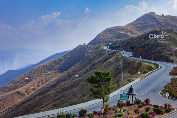 Chicamocha, Colombia - January 14, 2014: The road from Bucaramanga to San Gil in the Department of Santander in the South American country of Colombia, winds it's way through the Andes near the Chicamocha National Park and Canyon. It is late in the afternoon and the peaks cast shadows across the mountains. Horizontal format. Camera: Canon EOS 5D MII. Lens: Canon EF 24-70 mm F2.8L USM.